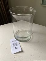 full view of clear glass hurricane candle holder on table