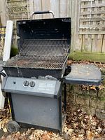 Full view of open BroilMate gas grill showing side shelf and base