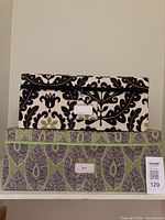 Two fabric storage boxes stacked, showing exterior patterns and size difference