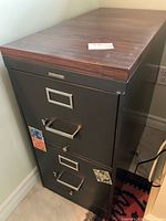 Full view of Steelcase two-drawer metal file cabinet with wood-grain top