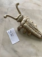 top view of cast iron insect boot jack showing overall form and paint wear