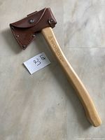 Full view of Woods hatchet with leather sheath in place
