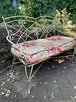 Full view wrought iron loveseat with cushion