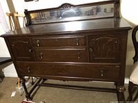 Front view of oak sideboard showing mirror, drawers, doors and hardware
