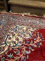 Corner and field showing red base color, floral design and border