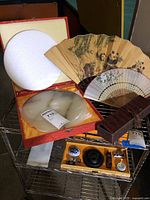 Group shot showing jade disc in box, calligraphy set, two fans and brocade box