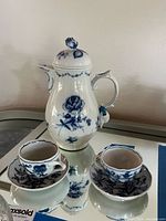 Full set showing coffee pot, two cups and saucers