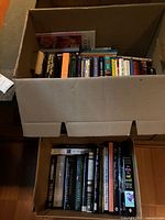 Two cardboard boxes filled with assorted books