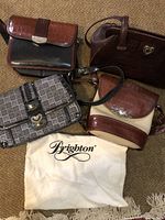 Overview of four handbags and Brighton dust bag