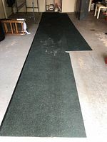 Full length view of two joined carpet runner sections laid on garage floor