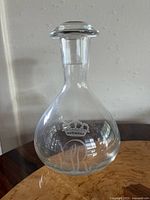 Full view of clear etched glass decanter on table