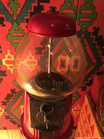 Front view of Carousel gumball machine showing globe, coin mechanism and stand