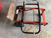 Top view of orange steel convertible hand cart showing frame and handle