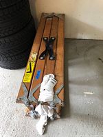 Ladder folded showing wood slats, hinges, carry handle, labels