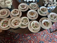 All plates laid out showing variety of floral patterns