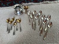 Entire lot showing spoons, cup and weighted vessel