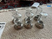 All six glass shakers showing bases and lids