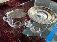Overview showing both glass creamers, oval sterling dish and round tray
