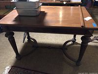 Full view of rectangular wooden library table showing top, legs and stretcher