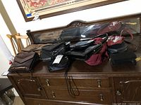 All ten bags displayed on dresser