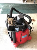 Overall view of Dirt Devil wet/dry vac with hose, wands, nozzle and manual