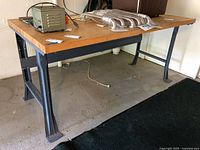 Full view of workbench showing wood top and steel frame