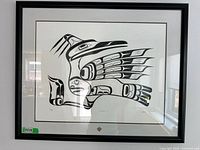 Full front view of the framed black and white Inuit print "Trickster" showing the entire artwork and framing.