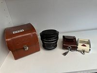 Image showing Heinz Kilfitt Makro-Kilar 90mm f/2.8 lens, brown Linhof leather case, and vintage Gossen Sixtry selenium exposure meter with case.