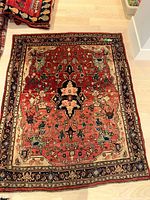 Full view of Persian rug showing overall design and color scheme