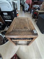 Top view of rustic wooden side table showing paneled top surface and natural wood grain.