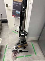 Full upright Shark Lift-Away vacuum with brush roll and attachments on floor