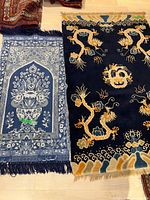 Both Persian rugs laid side by side on floor with clear view of designs and colors.