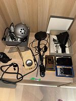Overview of lot showing silver robot lamp with power cord, microscope camera, transformer, magnifying glass, and 3 film holders on wood surface.