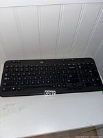 Front view of Logitech wireless keyboard showing full QWERTY layout with numeric keypad.