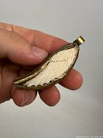 Full view of pendant in hand showing size and overall design