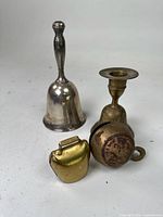 Group of four bells showing materials and shapes