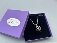 Necklace displayed in open purple 3 Wishes box