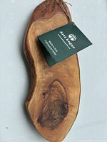 Front view of olive wood board with tag attached