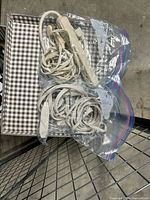 Two resealable bags containing one 6-outlet power strip and one extension cord