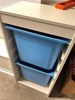 Full view of IKEA frame with two blue bins inserted