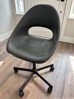 front view of black Ikea swivel chair with gray seat pad