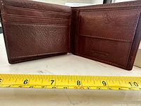 Open wallet interior showing card slots, bill compartment, coin pocket, tape measure indicating approx 21 cm width when open