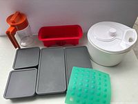 Group view of all items including pitcher, loaf pan, trays, mat and salad spinner