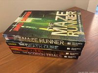 Stack of four Maze Runner series paperbacks showing spines