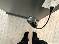 Top view of USB light plugged into outlet, showing housing and gooseneck