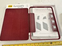 Open OtterBox Symmetry 360 Elite case in retail box with measuring tape