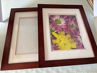 Front view showing both reddish brown wood frames with mats