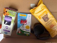 Group of leash, wipes, waste bags, safety light in box