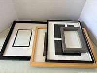 All four frames stacked showing colours, mats and relative sizes