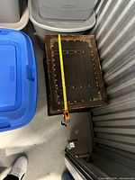 Closed chest with tape measure across top showing length